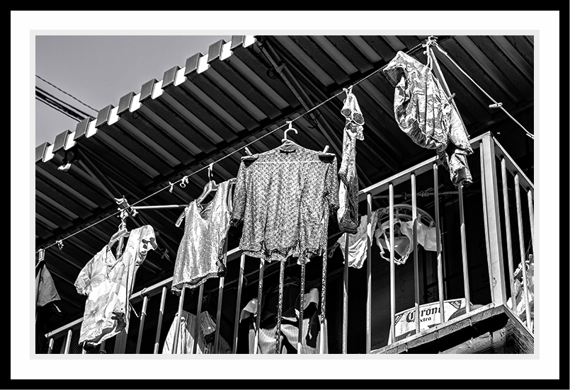 Clothes hanging on the patio to dry.